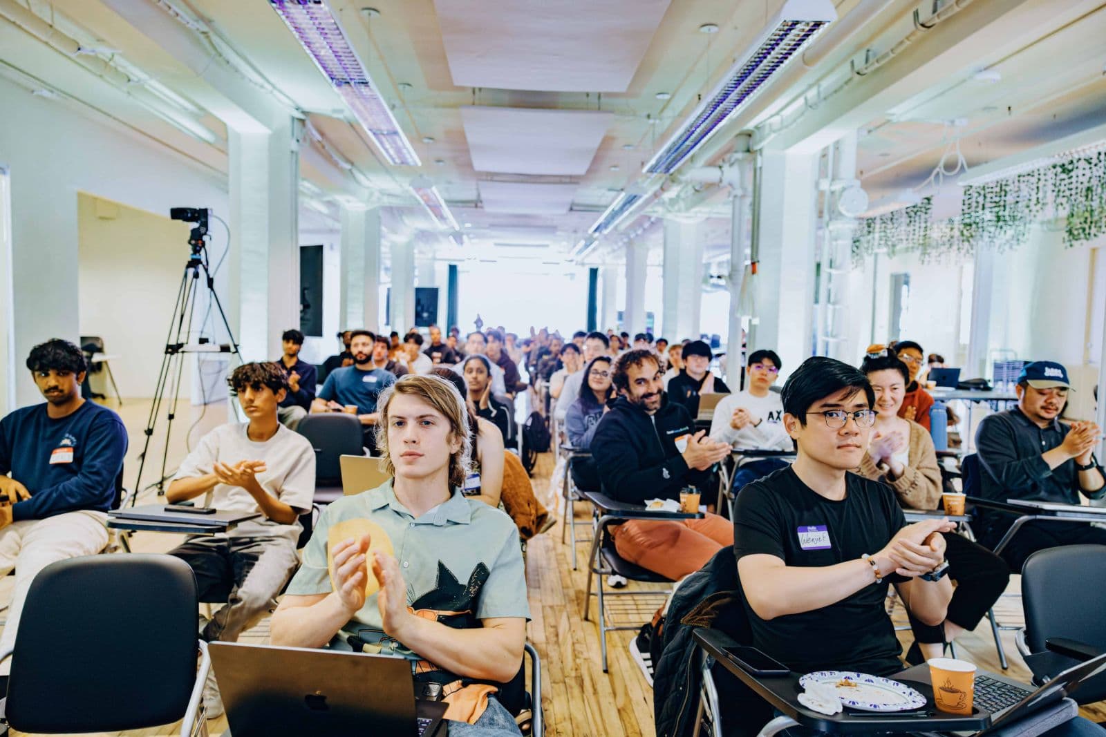 Startup team collaborating intensely on their project at TRAE Hackathon in SF Bay Area by JY Studio